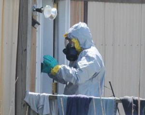 A DEA agent prepares to enter the suspects' trailer.