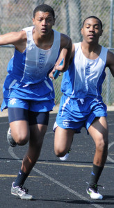 New Kent's Kyle Coles takes the baton from teammate William Bradby in the first exchange in the 4x100 meter relay.