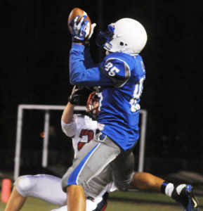 New Kent wide receiver Trent Orie leaps higher than Grafton defender David Dobbins to haul in a touchdown pass for the Trojans’ first score.
