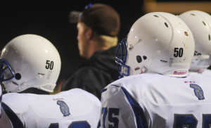 Trojan players wear Vick’s number 50 on their helmets for the Bruton game.