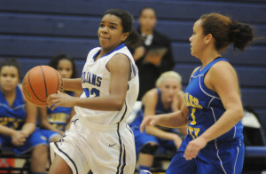 New Kent's Logyn Mills drives the ball up the floor with Charles City's Hailey Holmes in pursuit.Alan Chamberlain photo