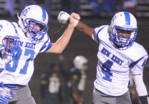 New Kent's Julian Thacker (37) and R.J. Morris celebrate after Thacker's winning placement.