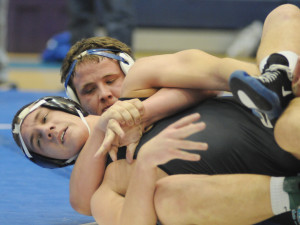 New Kent's Wilson Gregory wraps up Glen Allen's Nick Majzer to gain a 6-0 decision.