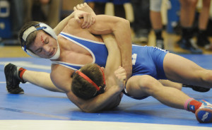 Blood from a cut on the forehead fails to slow New Kent's B.C. Laprade as he works his way to a technical fall over Mountain View's Justin Watkins.