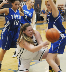 Trapped on the baseline by York's Mahlina Shorts (10) and Megan Eckstein, New Kent's Brynne Jones dives to her knees to fire an outlet pass to a teammate after controlling a rebound.