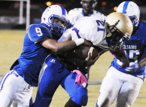 New Kent defender Lamont Brandon drags down Smithfield ball carrier William Robinson.
