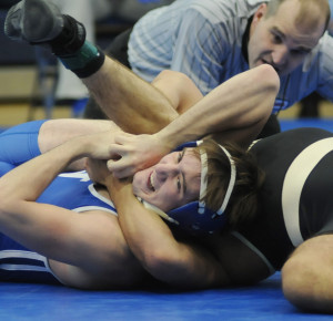 New Kent's Trent Ragland struggles to overcome King William's David Jones. Ragland later recorded a pin.
