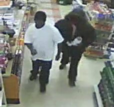 Another pic of the suspects shows them approaching the counter of the 7-Eleven store.